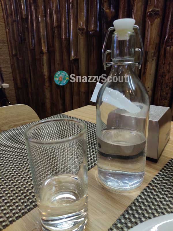 Glass water bottle served during meal